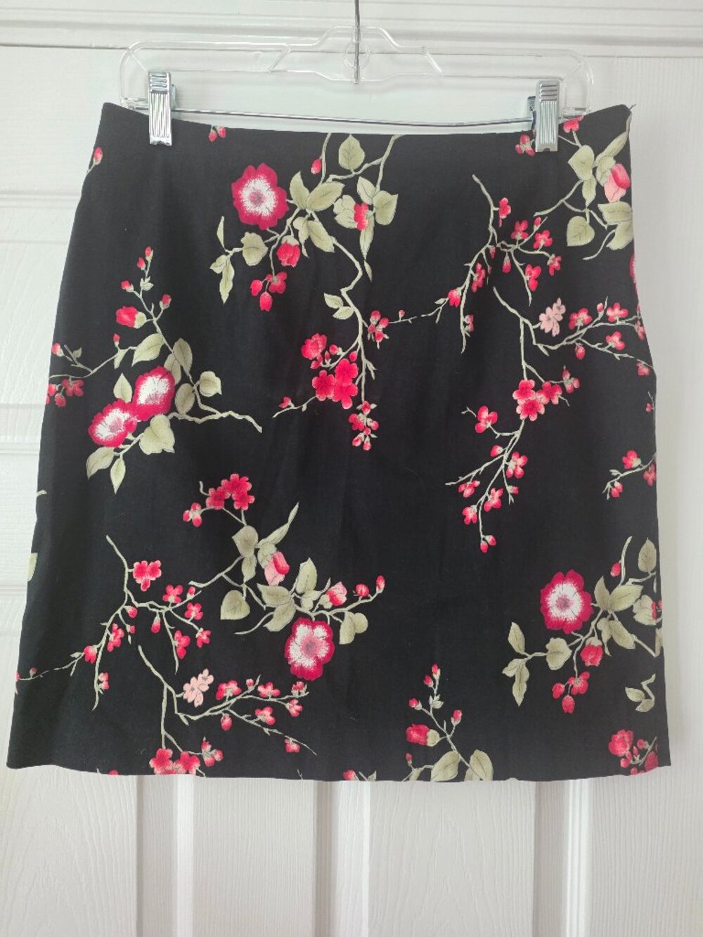 Women's short skirt. Black with pink floral design.